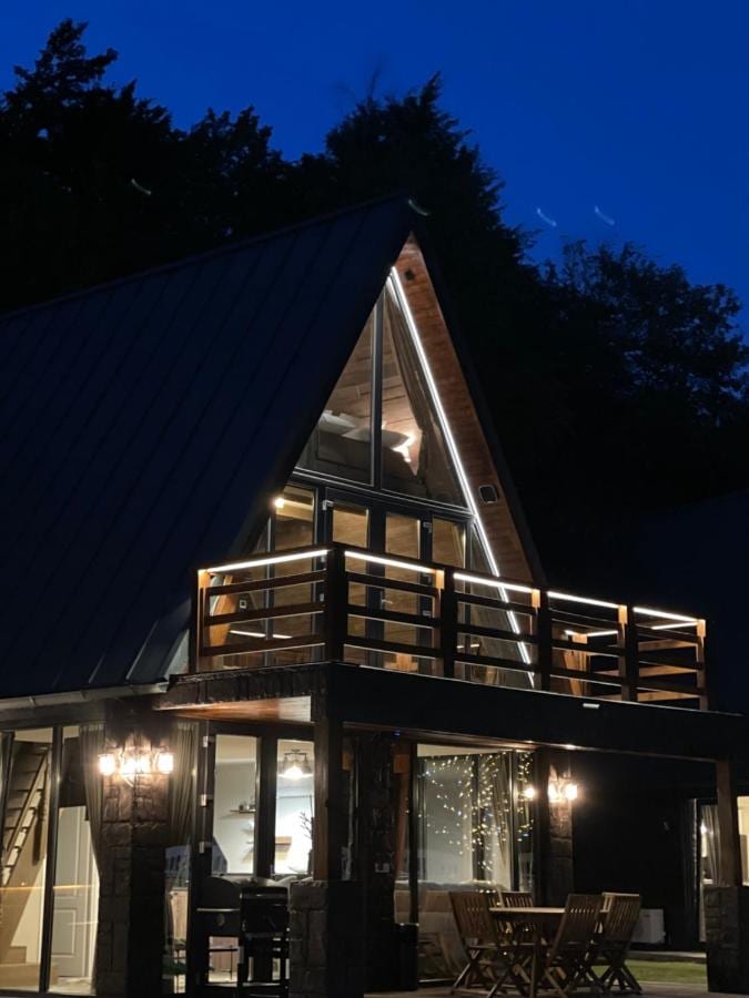 Cabană A-frame luminată seara